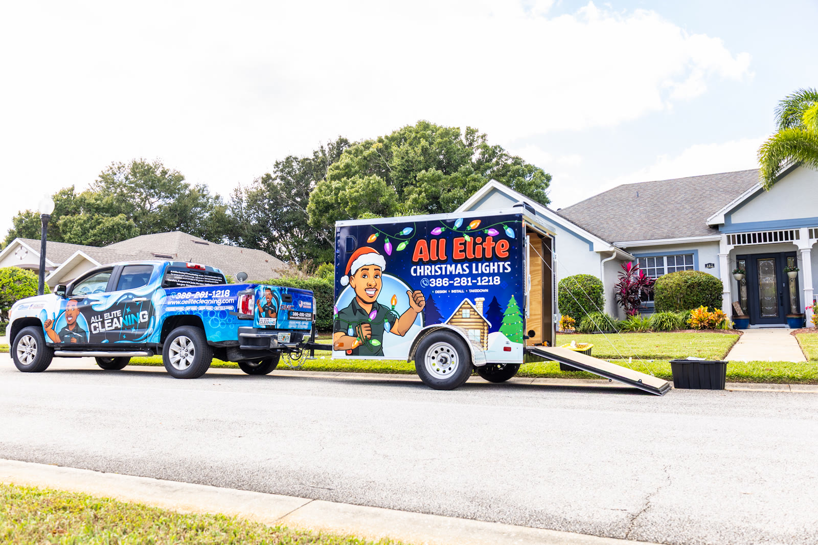 All Elite Christmas Lights trailer and branded truck parked together